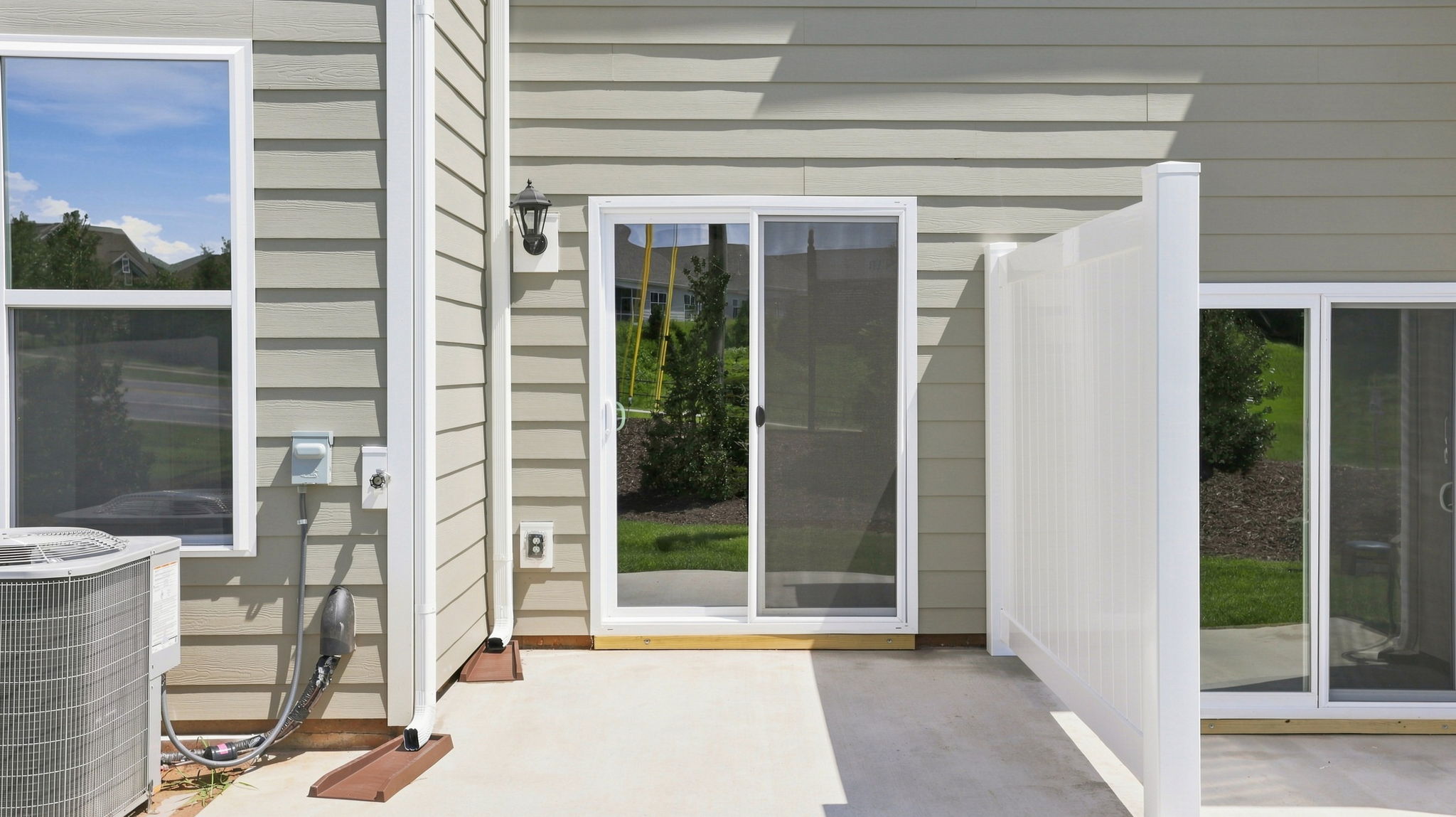 View of back patio and sliding glass doors