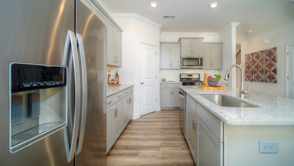 Open concept kitchen with island and stainless steel appliances