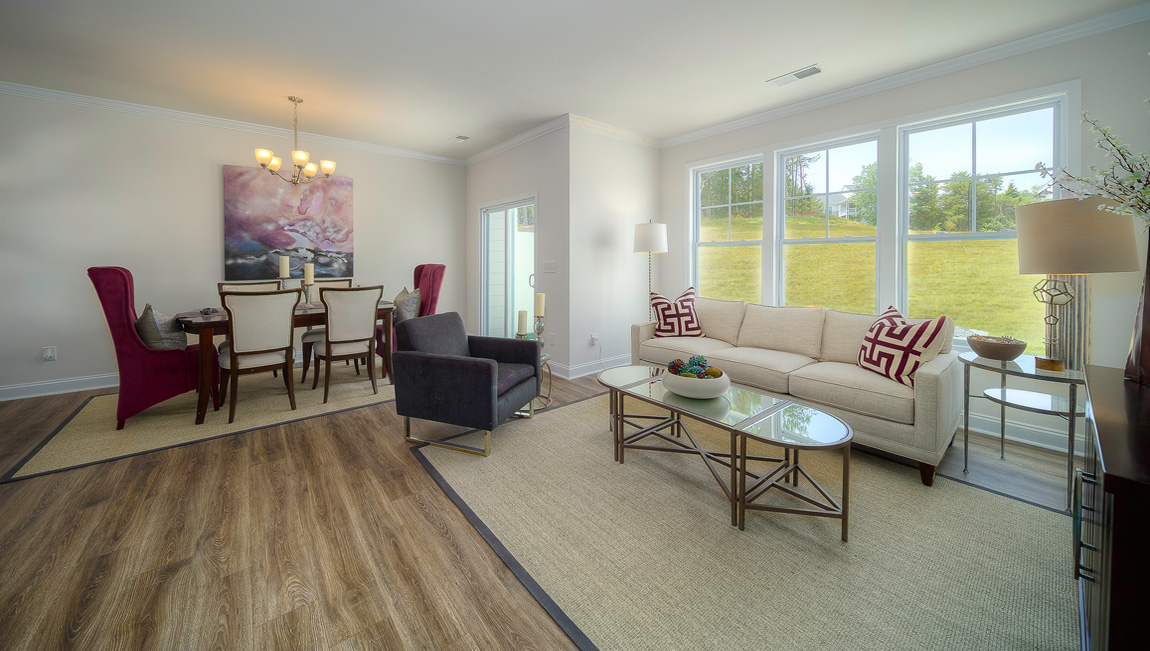 Carpeted living room with large windows