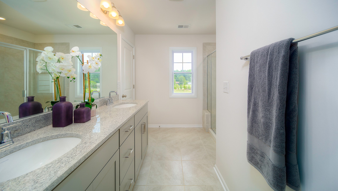 Primary bathroom with double vanity and shower