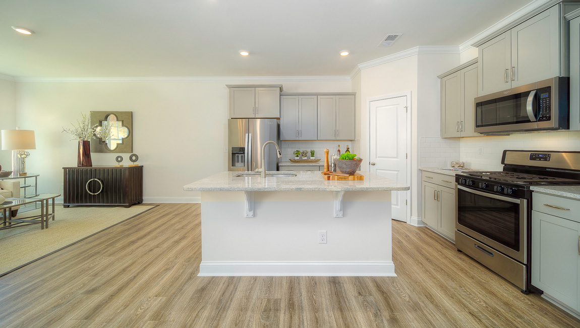 Open concept kitchen with island and stainless steel appliances