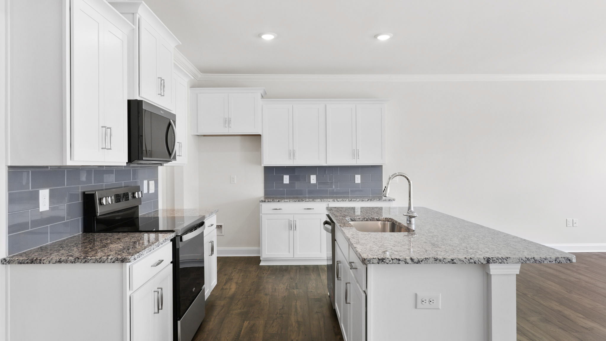 Open concept kitchen with large island and stainless steel appliances