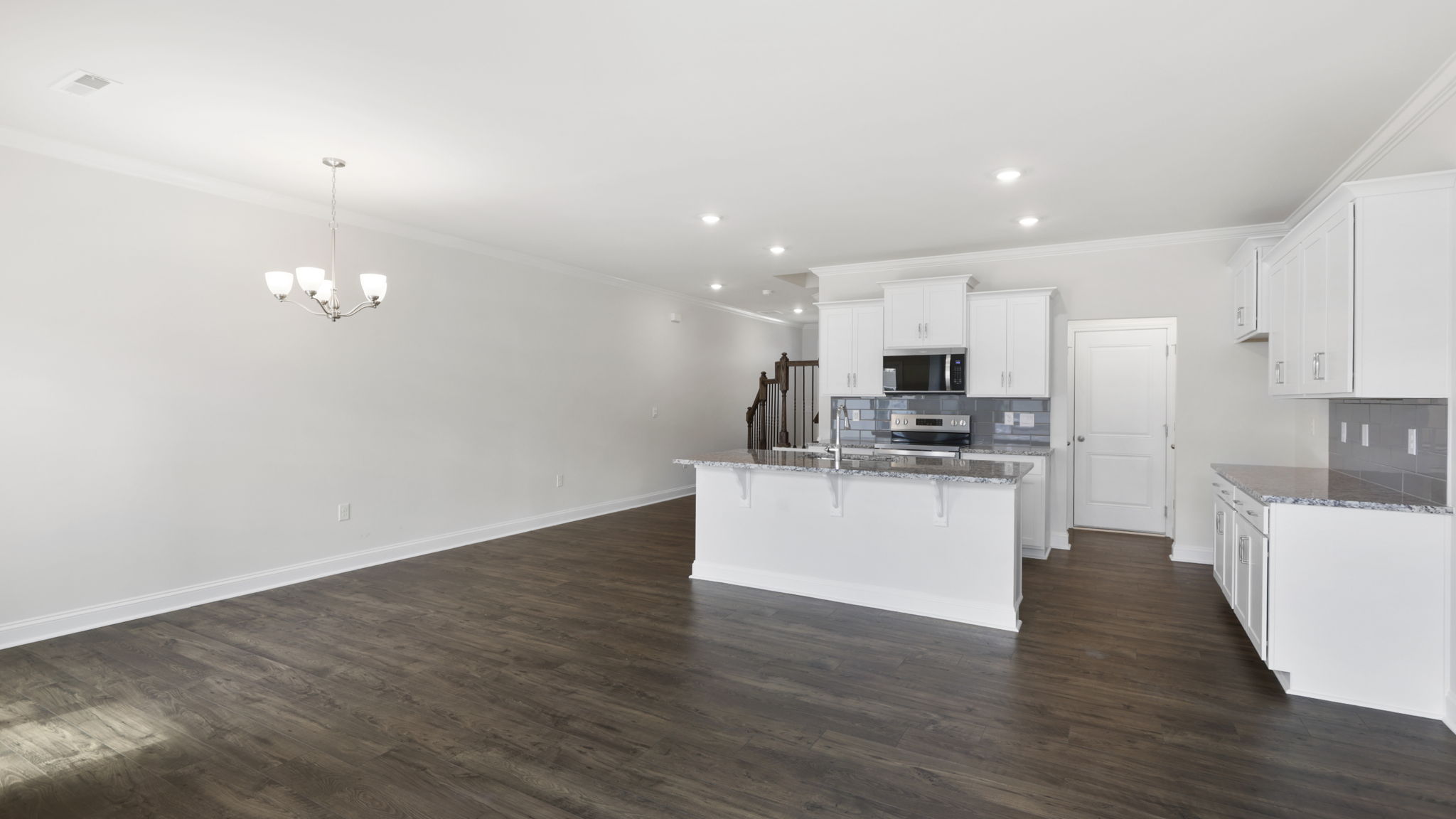 Open concept kitchen with large island and stainless steel appliances