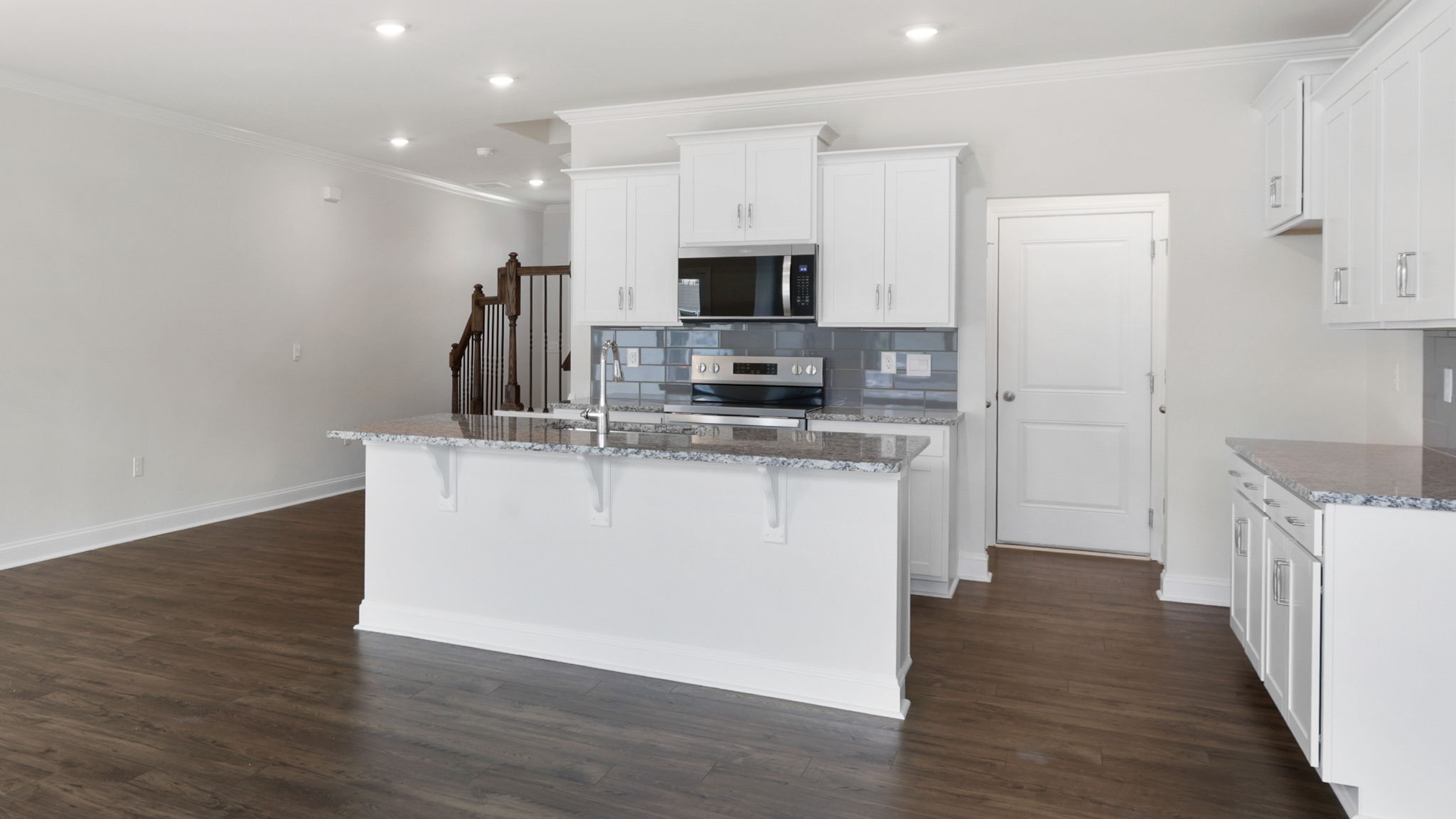 Open concept kitchen with large island and stainless steel appliances