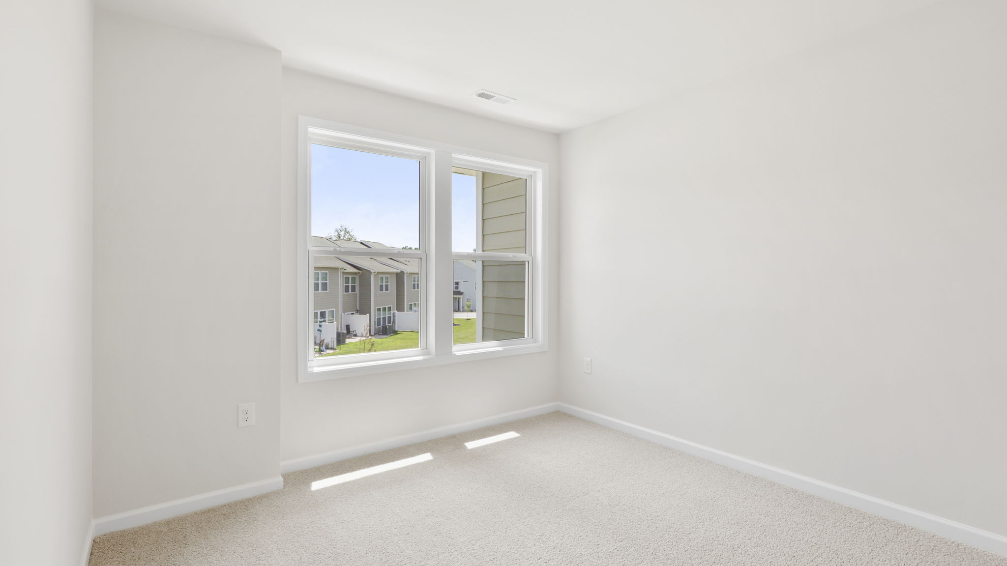 Carpeted bedroom with large windows