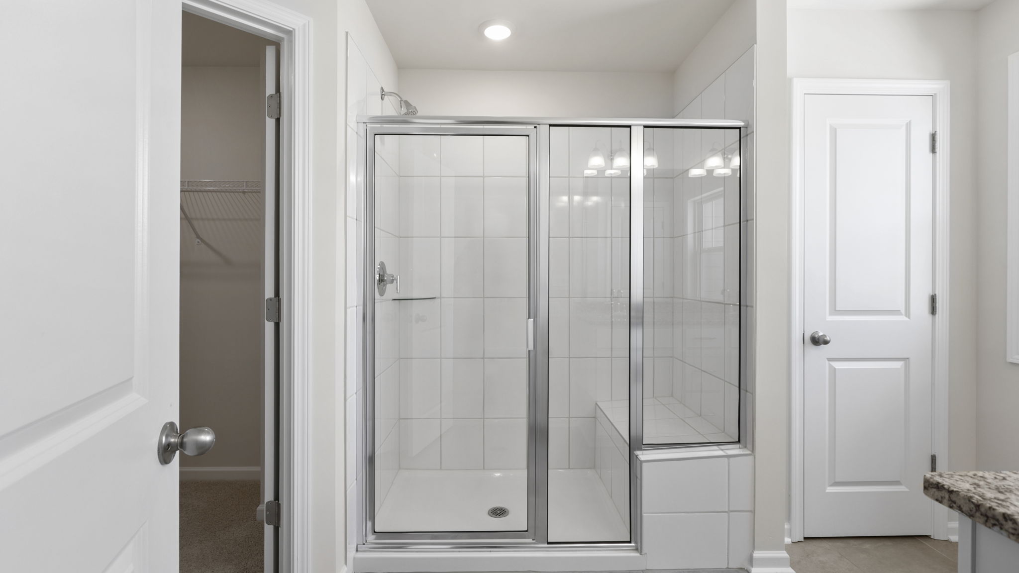 Primary bathroom with walk in shower and linen closet