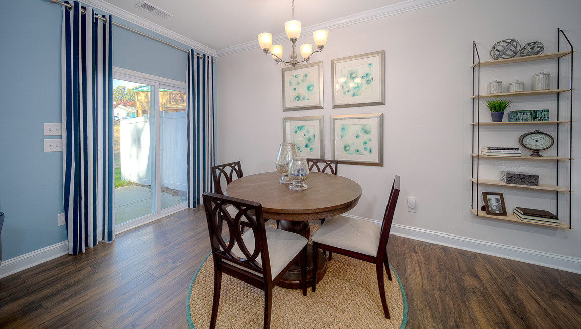 Dining room area with wood floors and sliding glass back door