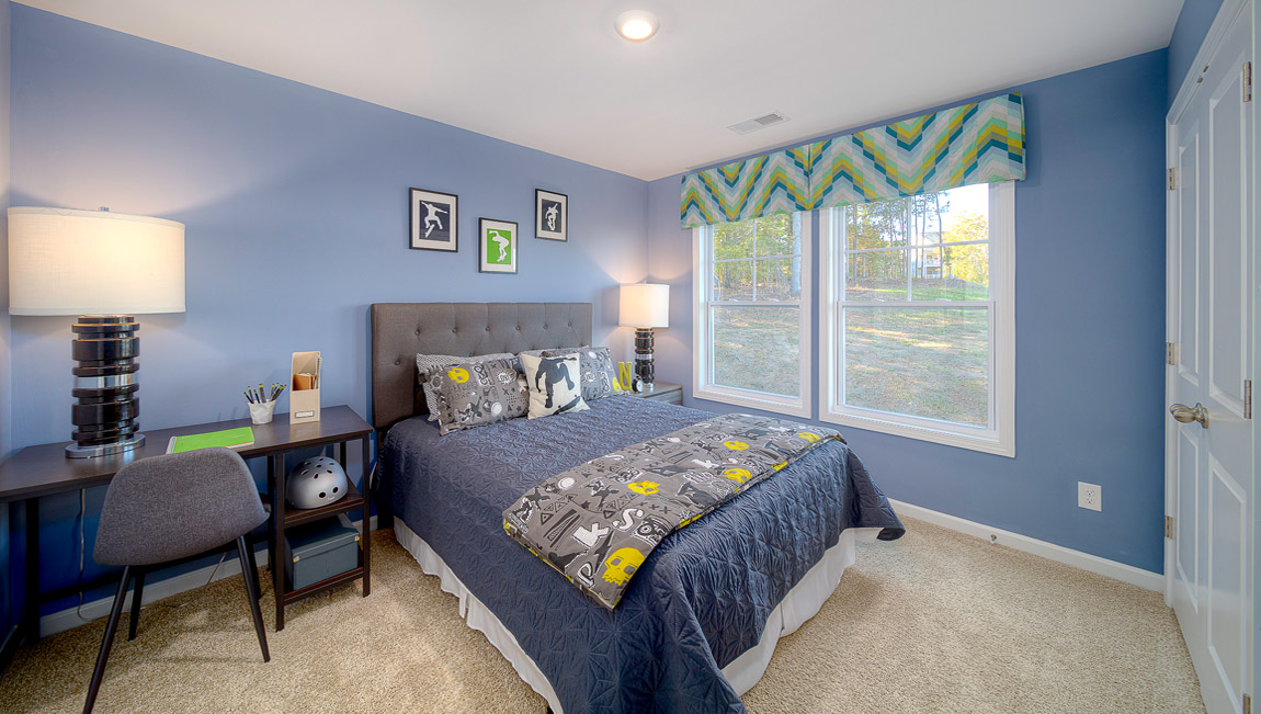 Carpeted bedroom with large window