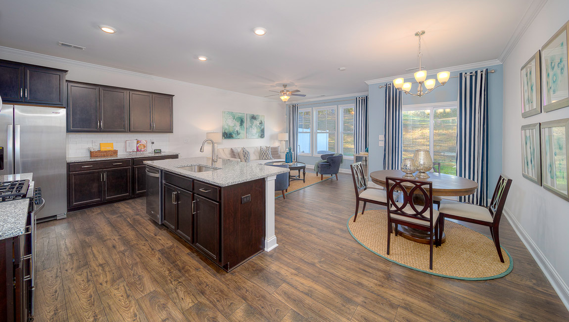Kitchen and island with brown cabinets, and stainless steel appliances