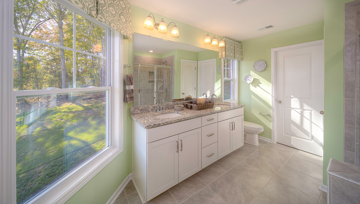 Primary bathroom with double vanity and walk in shower
