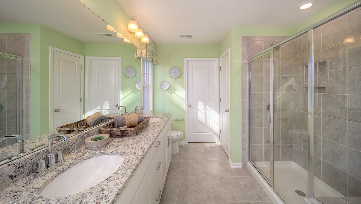 Primary bathroom with double vanity and walk in shower