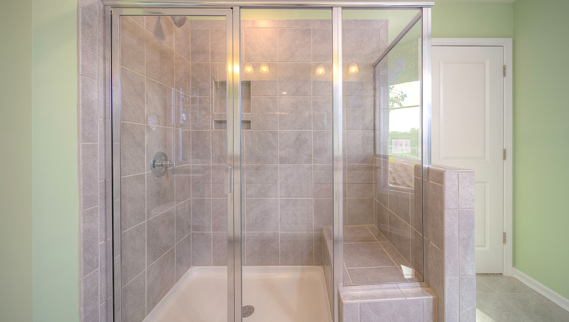 Primary bathroom with double vanity and walk in shower