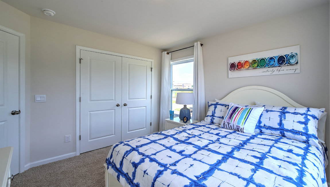 Carpeted bedroom with large windows