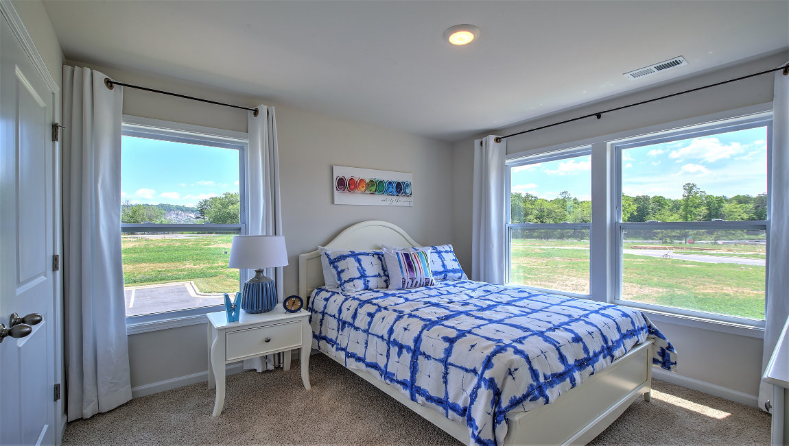 Carpeted bedroom with large windows