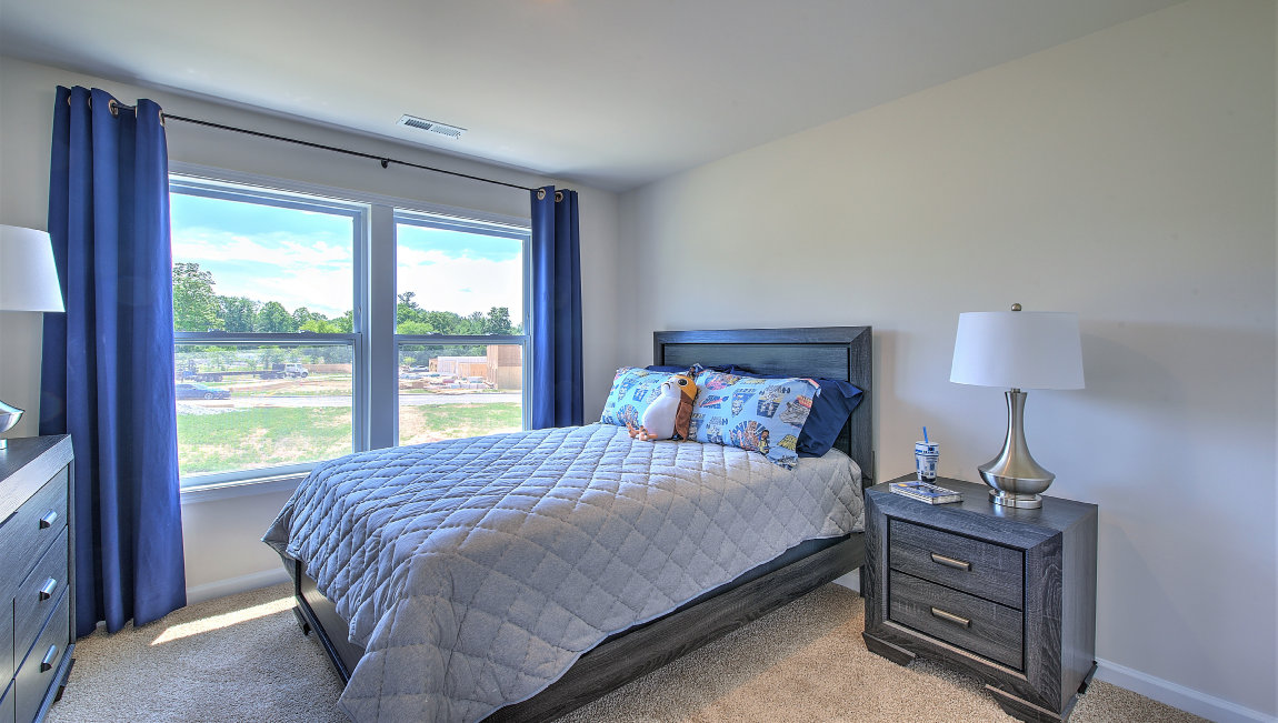 Carpeted bedroom with large windows