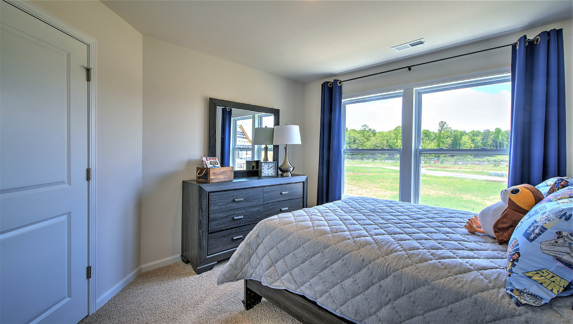 Carpeted bedroom with large windows