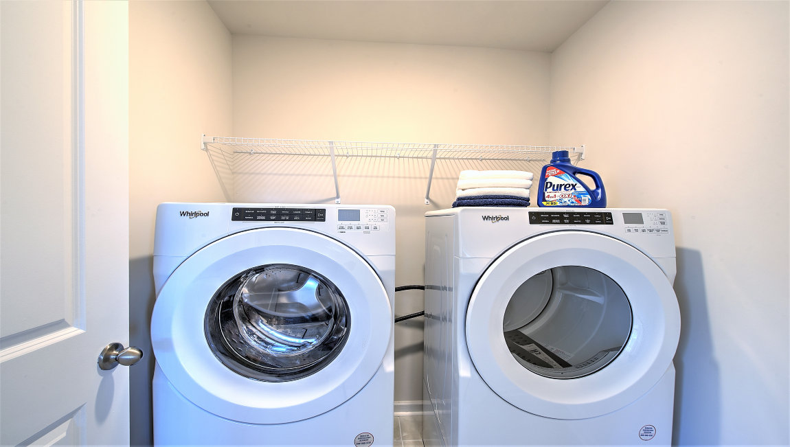 Laundry room with washer, dryer and shelving