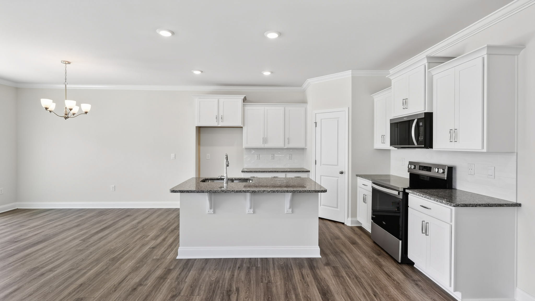 Open concept kitchen with large island and stainless steel appliances