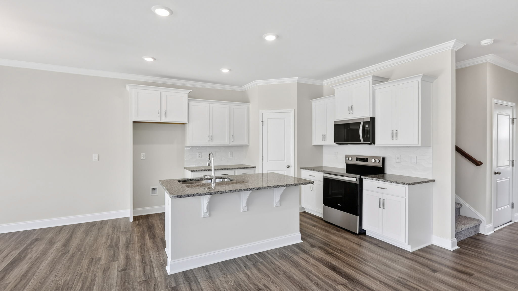 Open concept kitchen with large island and stainless steel appliances