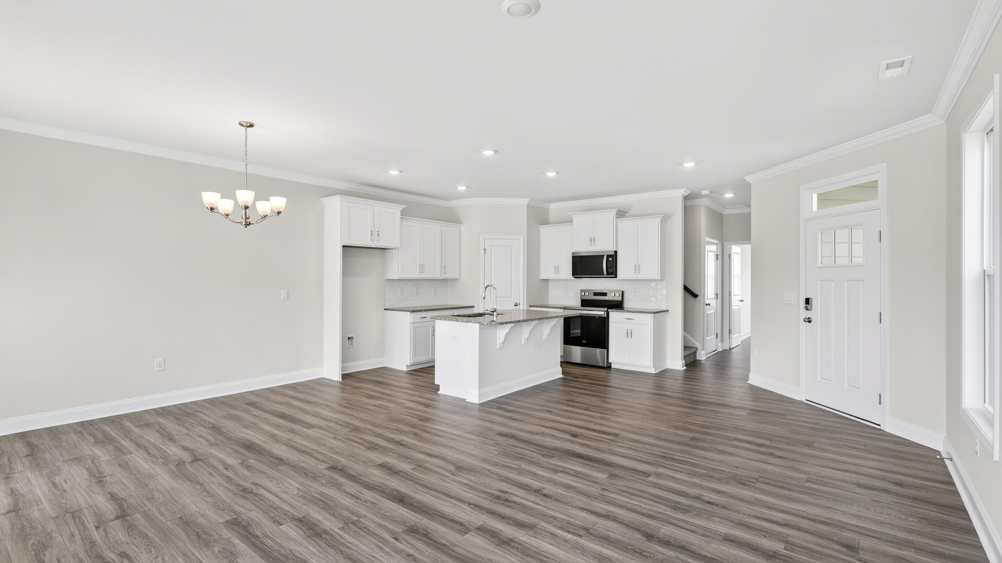 Open concept kitchen with large island and stainless steel appliances