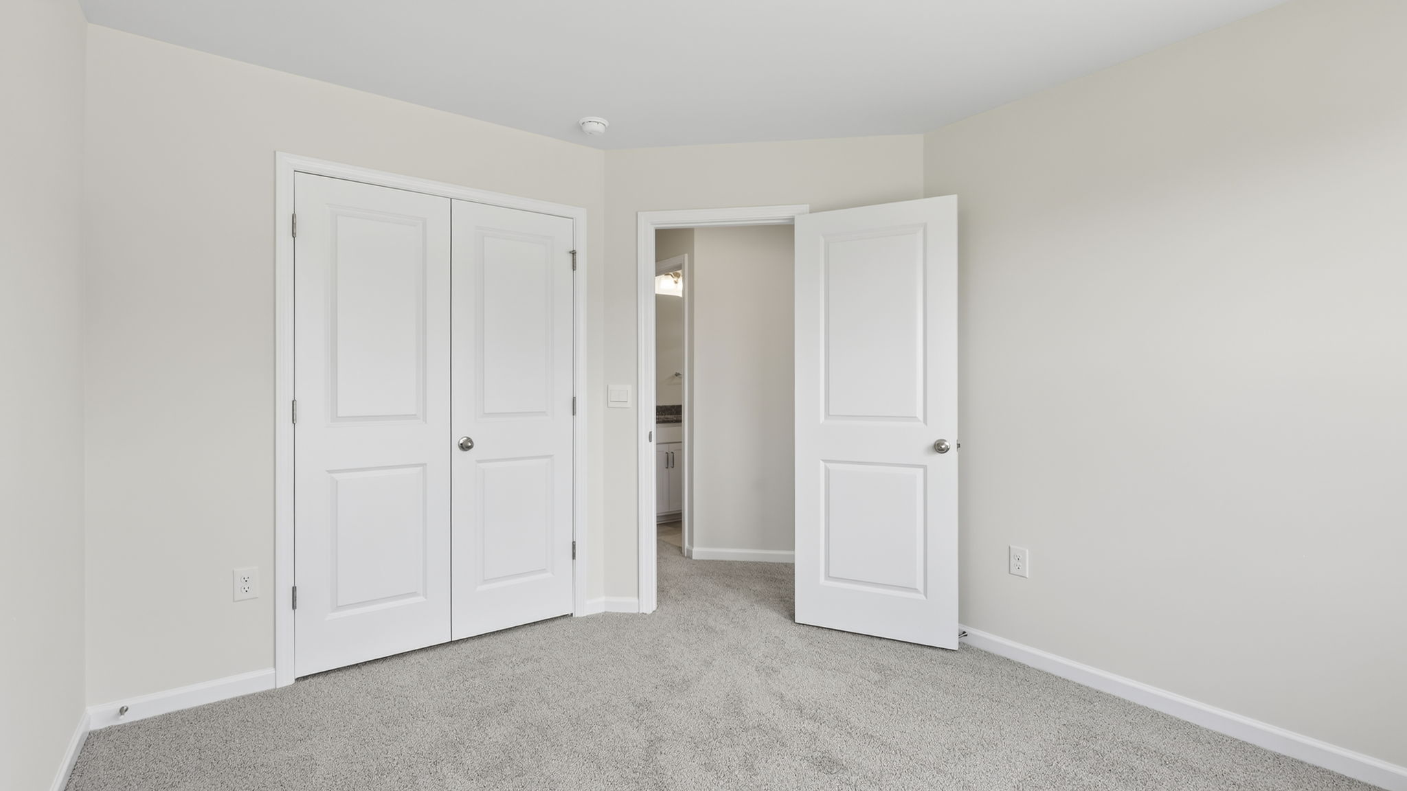 Carpeted bedroom with cloet