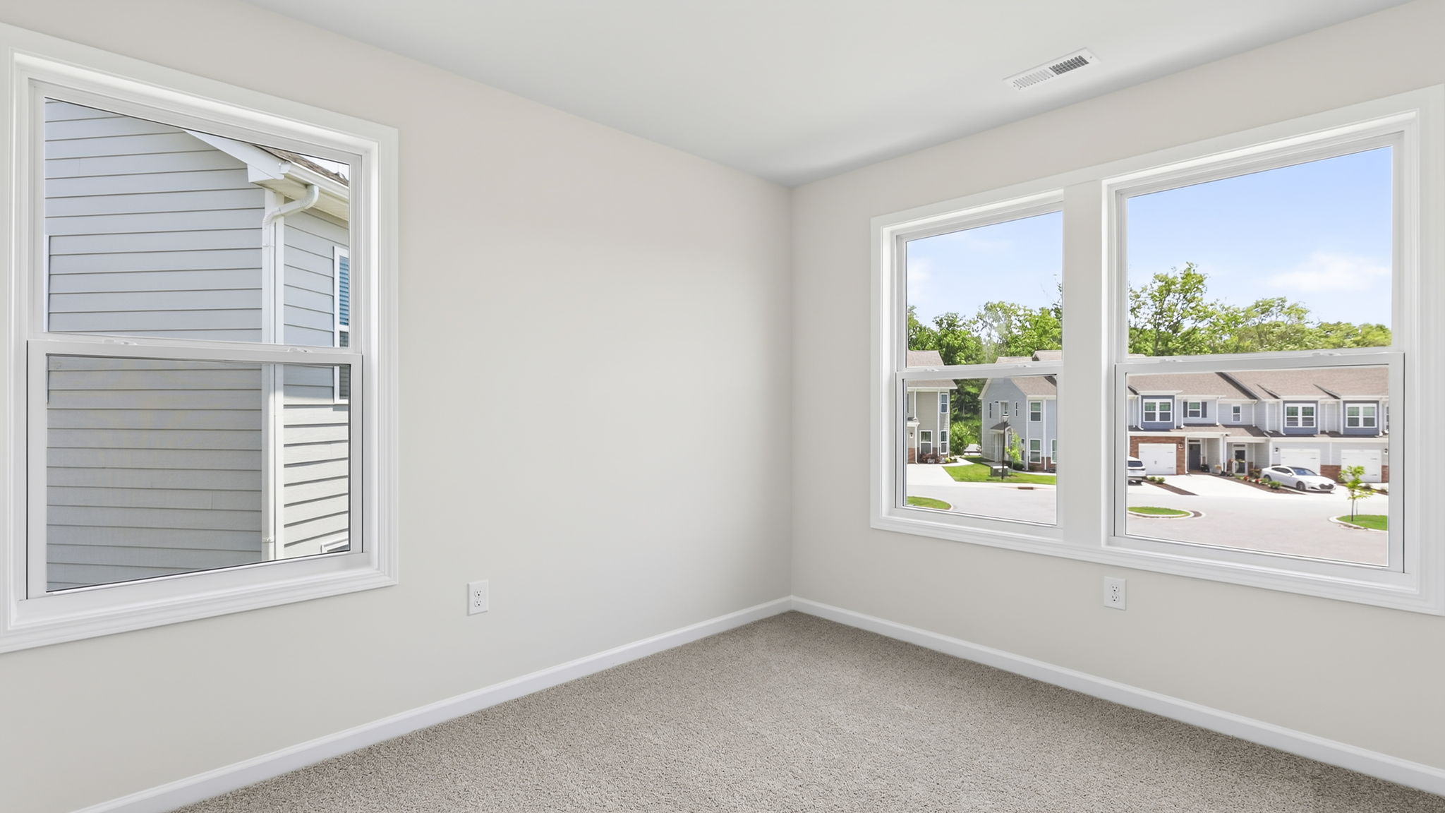 Carpeted bedroom with large windows