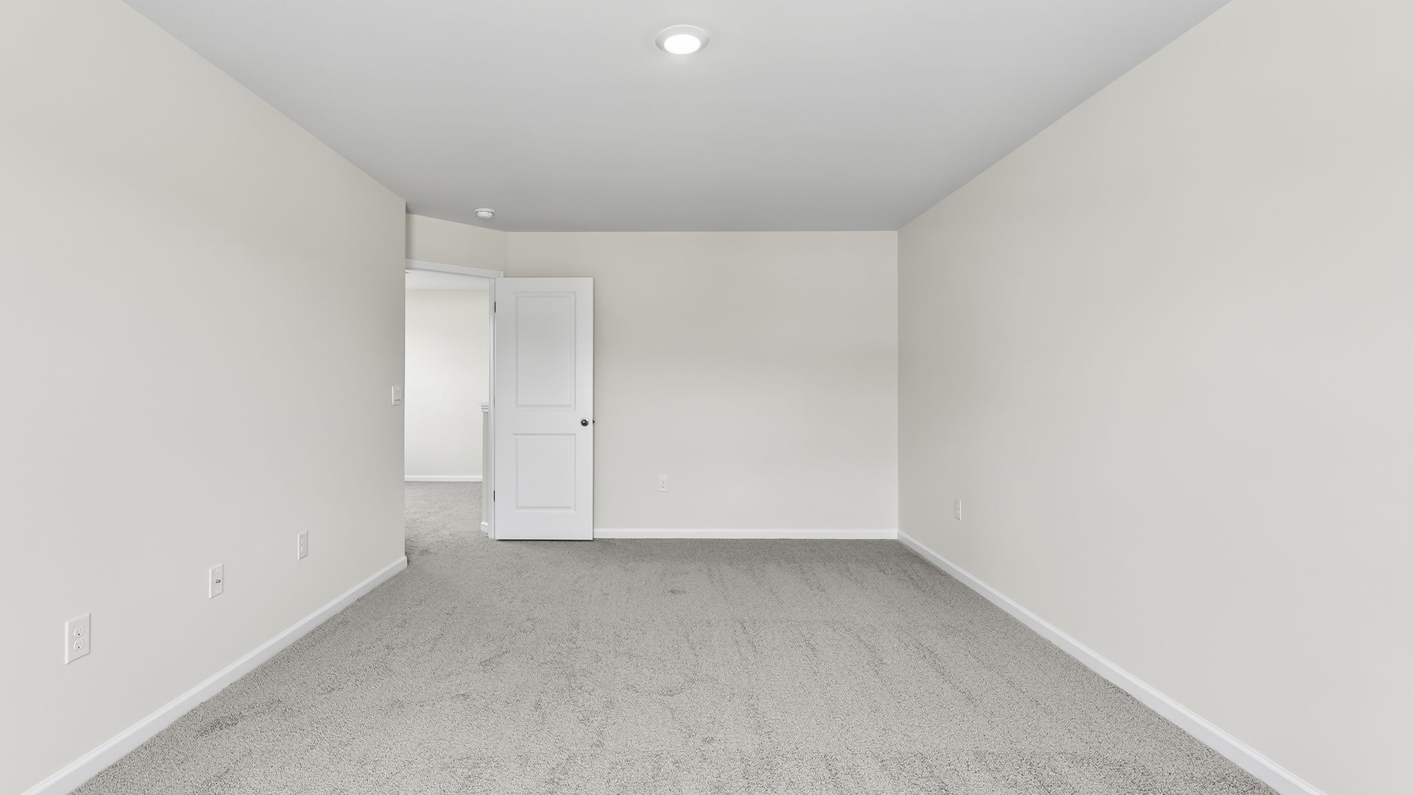 Carpeted bedroom with closet