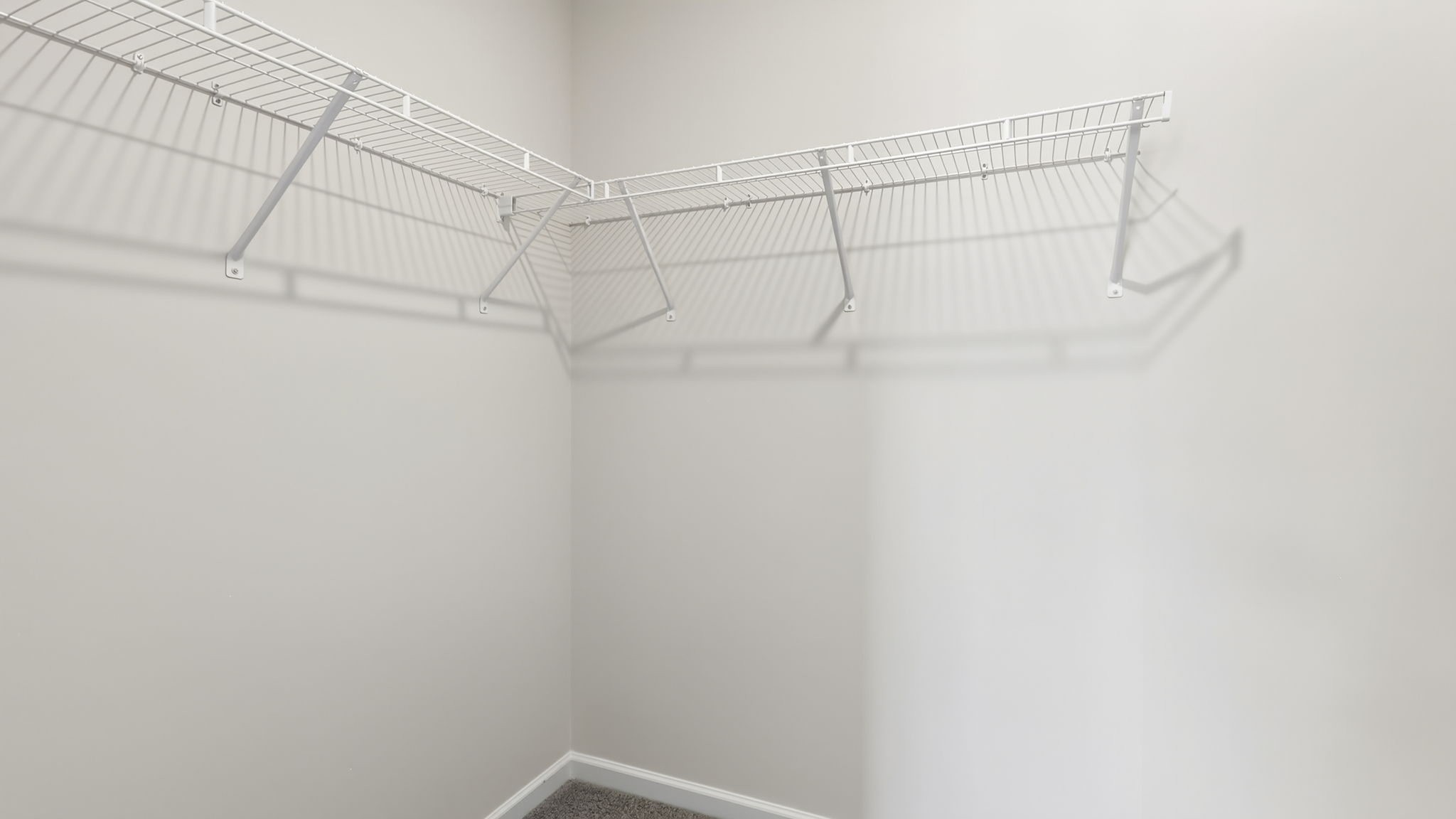 Primary walk in closet with shelving