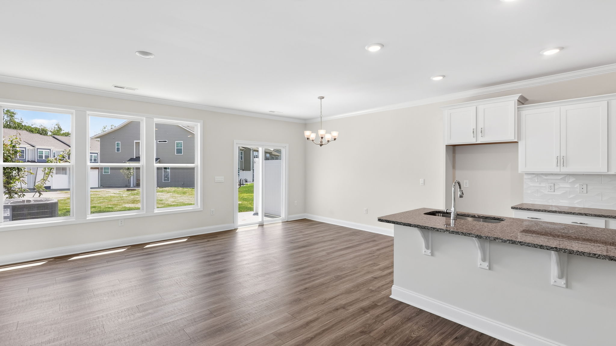 Open living area with kitchen island and windows