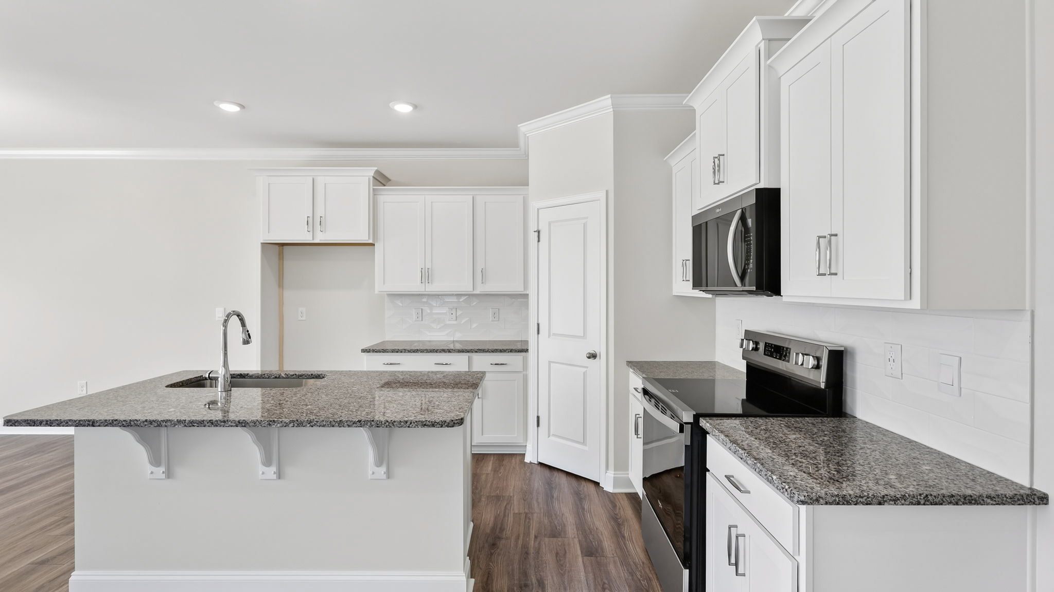 Open concept kitchen with large island and stainless steel appliances