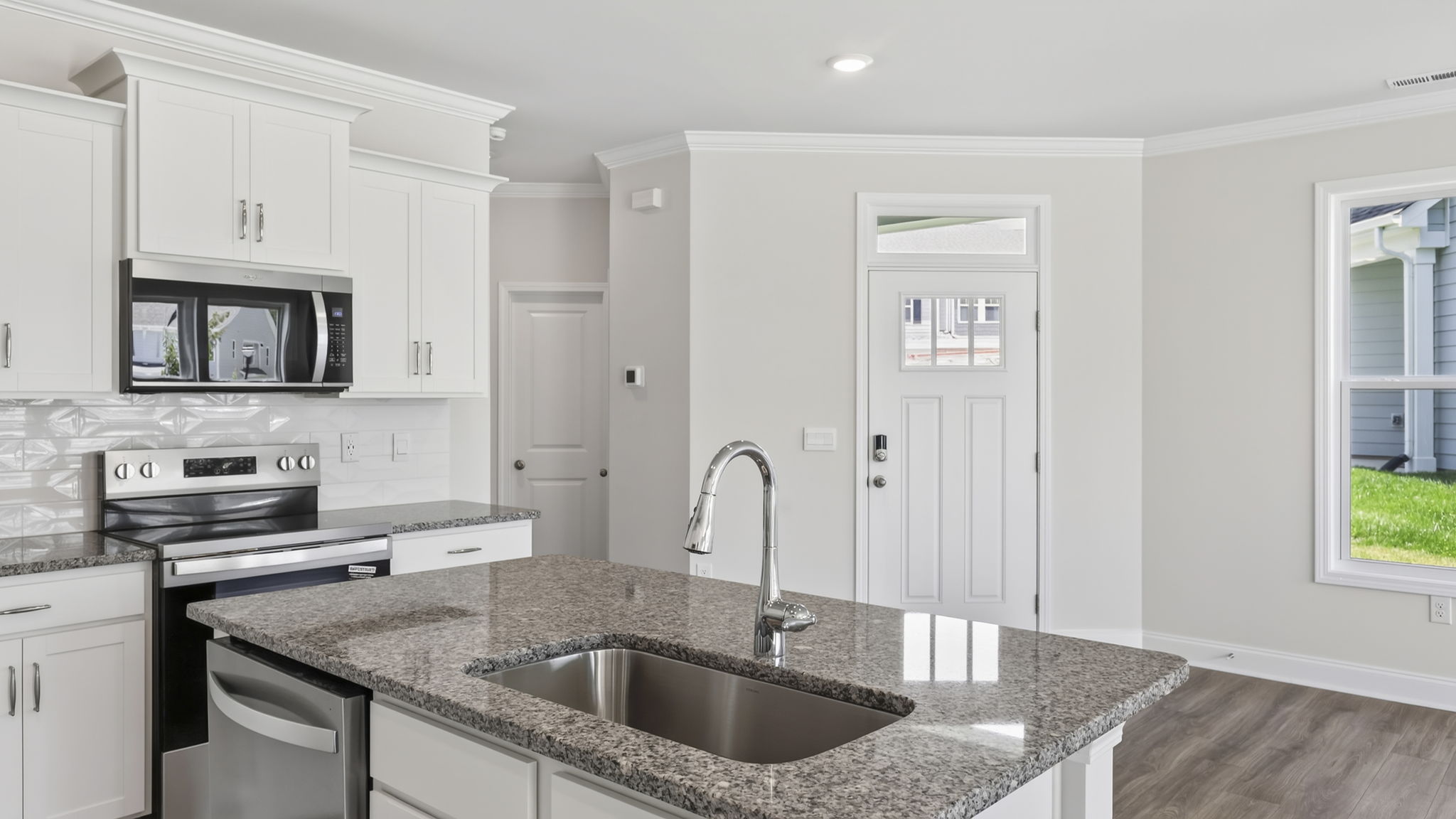 Open concept kitchen with large island and stainless steel appliances