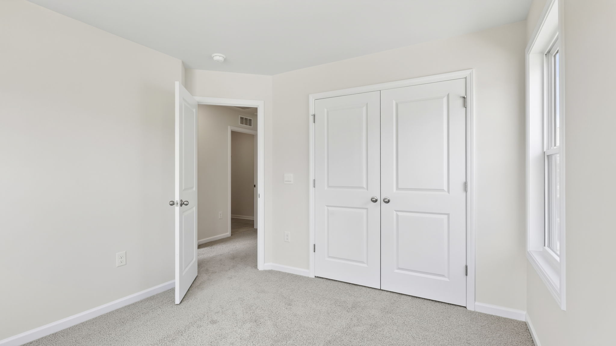 Carpeted bedroom with closet