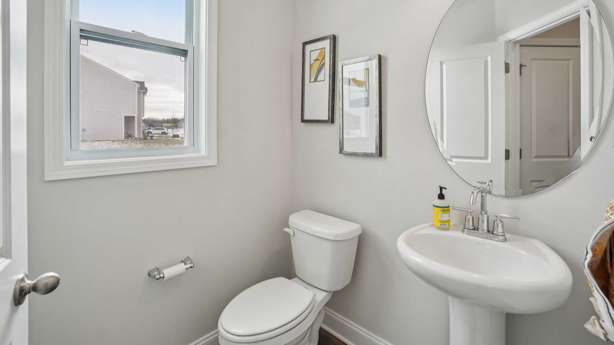 Half bathroom with window and sink
