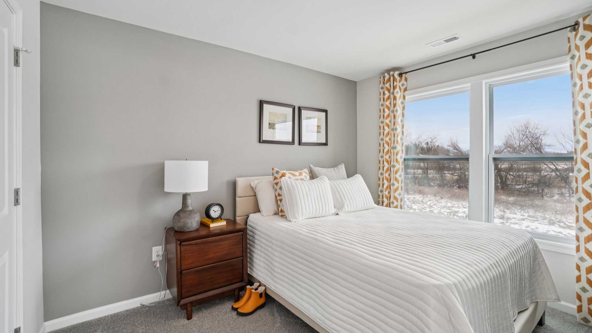 Carpeted bedroom with large windows