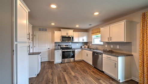 Kitchen with white cabinets, granite counters, and stainless steel appliances