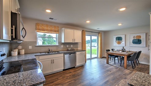 Kitchen with white cabinets, granite counters, and stainless steel appliances