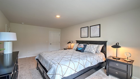 Carpeted bedroom with large windows