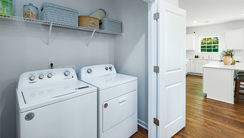 Laundry room with racks above machines