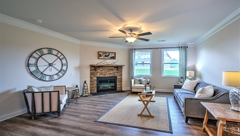 Open living room with fireplace and two small windows