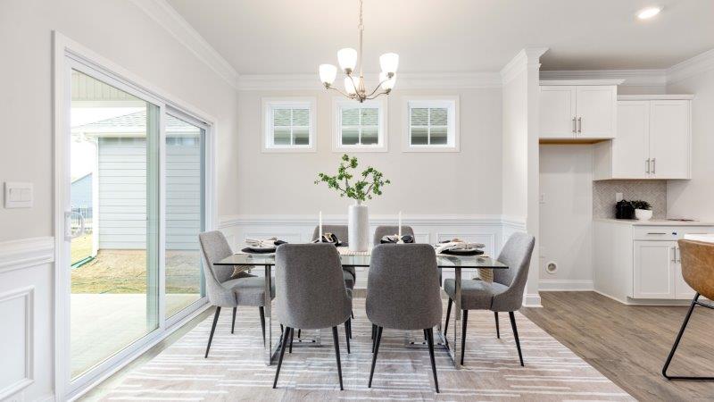 Arlington dining area beside kitchen and sliding glass doors