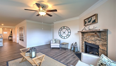 Open living room with fireplace and two small windows