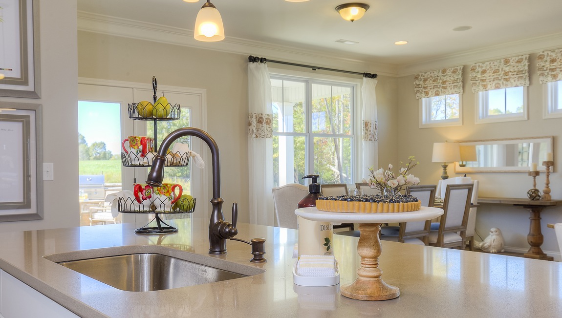 Kitchen and island with wood floors, white cabinets, breakfast area at island bar, and stainless steel appliances