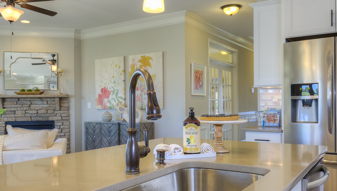 Kitchen and island with wood floors, white cabinets, breakfast area at island bar, and stainless steel appliances