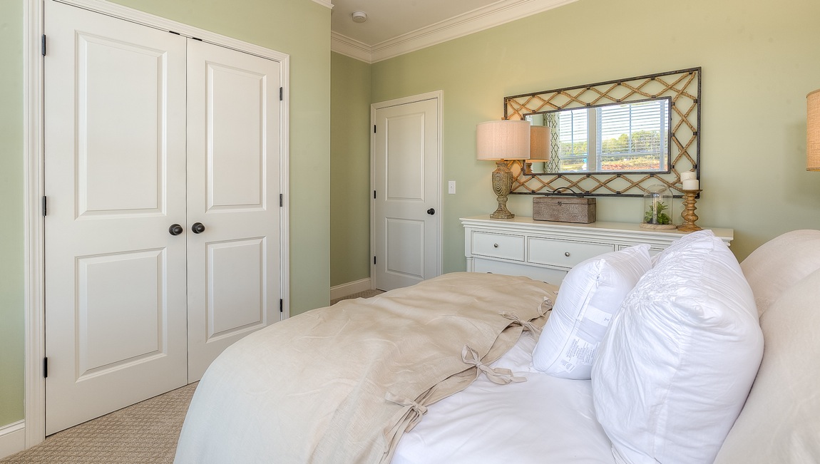 Carpeted bedroom with large window