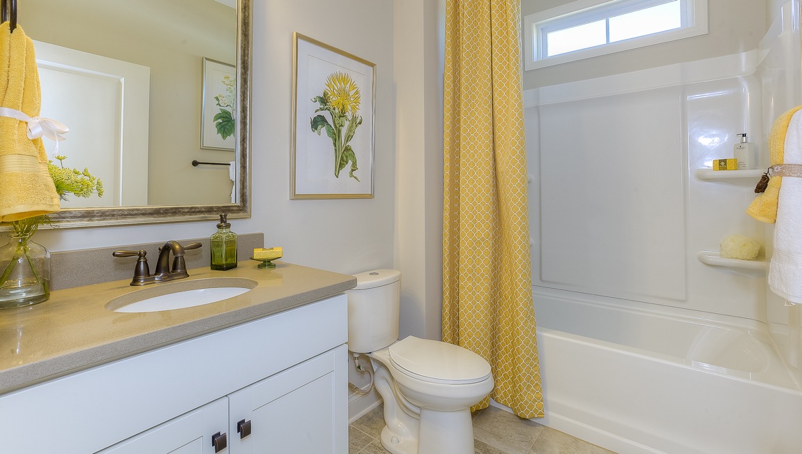 Bathroom with white cabinets and bathtub