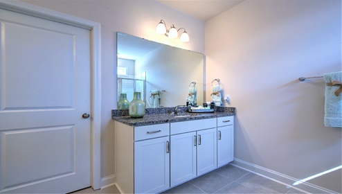 Bathroom with two counters and sinks, glass door shoer