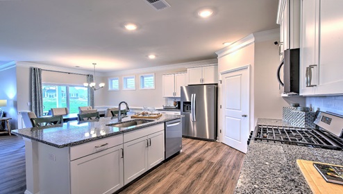 Kitchen and island, white cabinets, wood floors