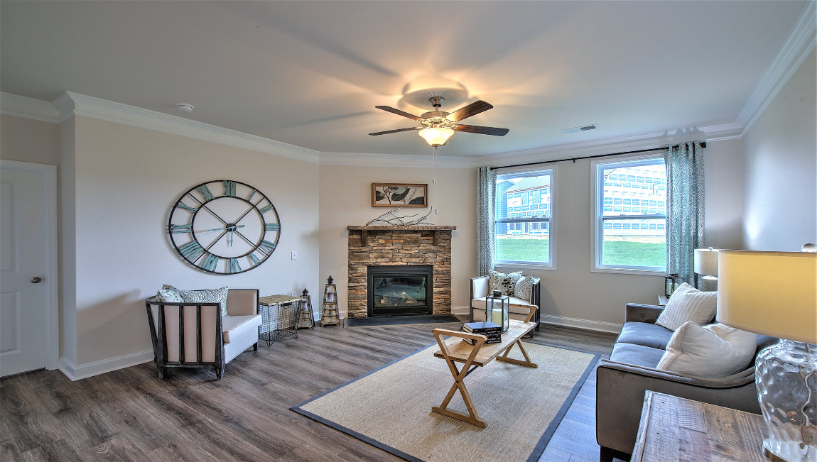 Open living room with fireplace  and two small windows