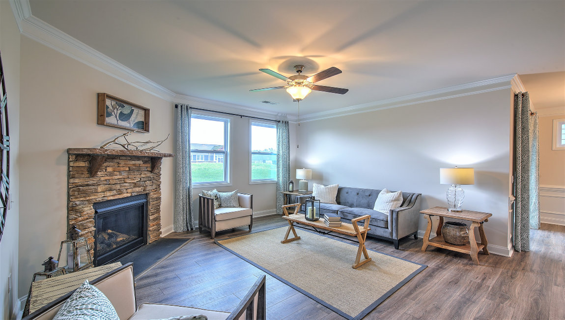 Open living room with fireplace  and two small windows