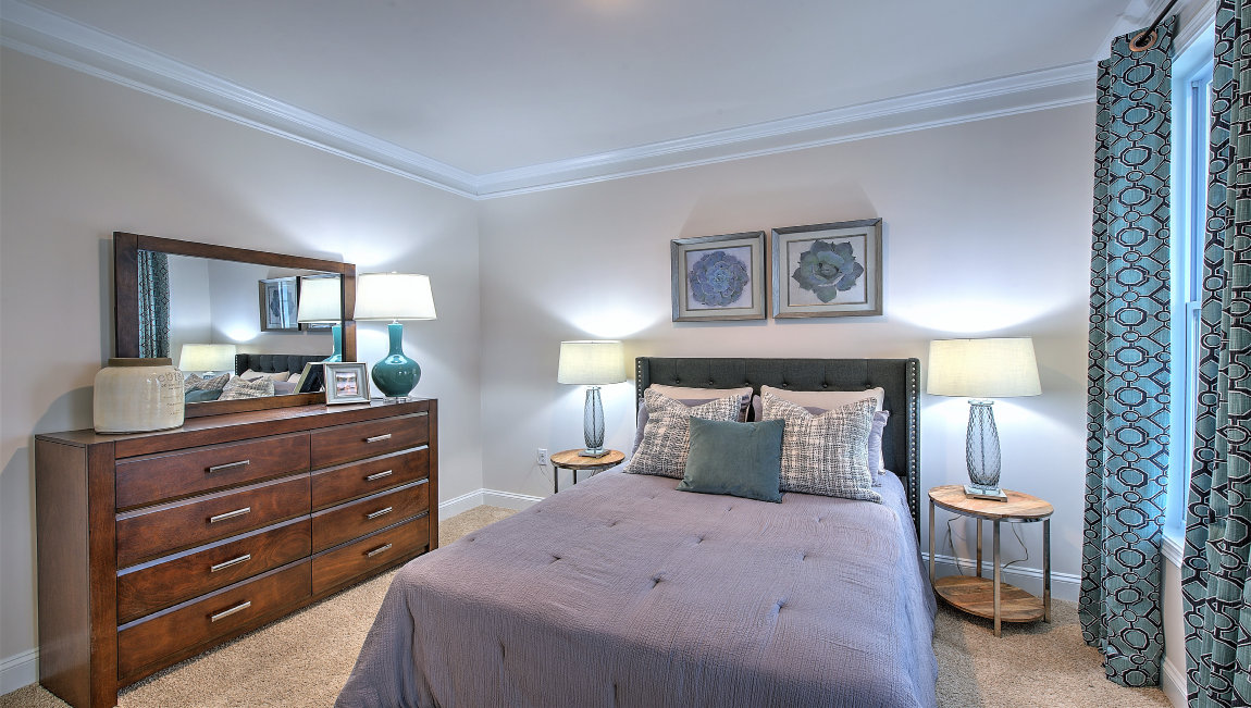Carpeted bedroom with two windows